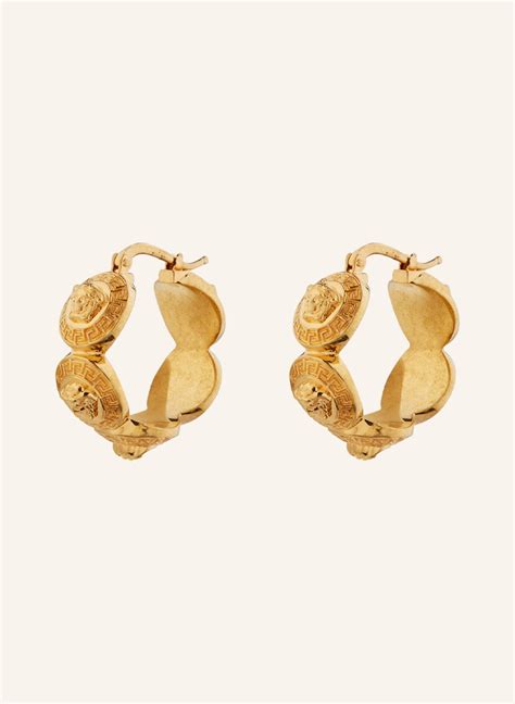 VERSACE Creole earrings in gold .